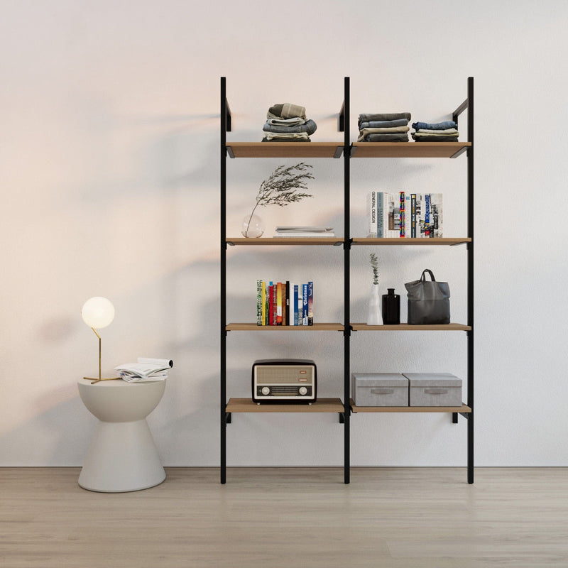 Hellgraue Wand mit schwarzem Metallregal aus Holzböden, dekorativen Gegenständen und Beistelltisch mit Lampe links daneben