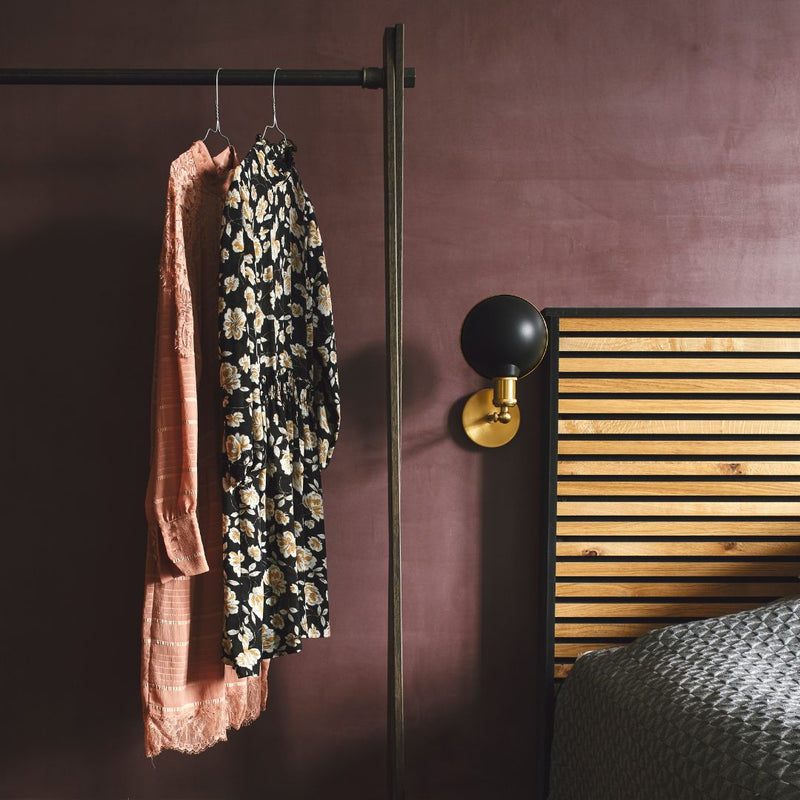 Freistehender Kleiderständer aus Räuchereiche mit dunklen Eisenrohren als Garderobe im Schlafzimmer rustikaler Stil